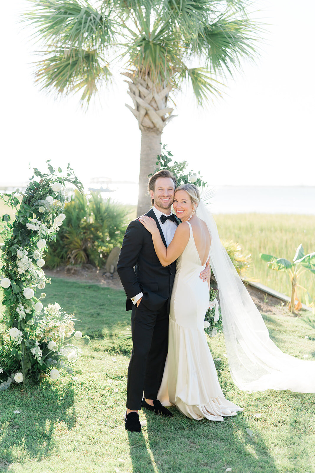 Waterfront fall wedding in Charleston. Bride and groom portraits at wedding ceremony site. Destination wedding in Charleston.