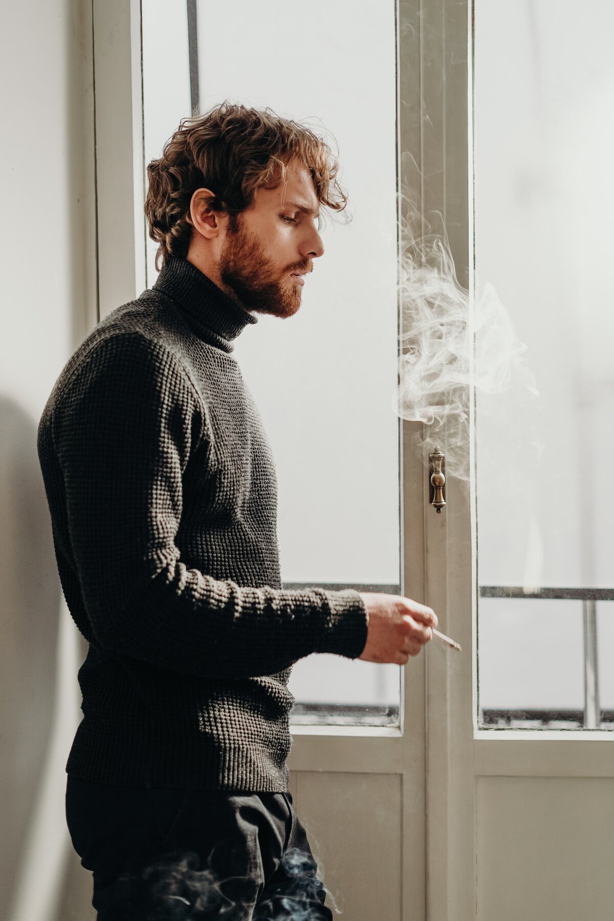 side-view-photo-of-man-in-black-sweater-standing-beside-3692904