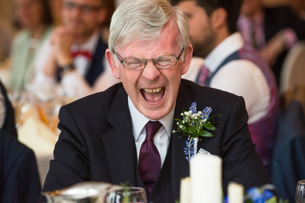 father of the bride laughing out loud at the wedding reception in hotel in Kerry