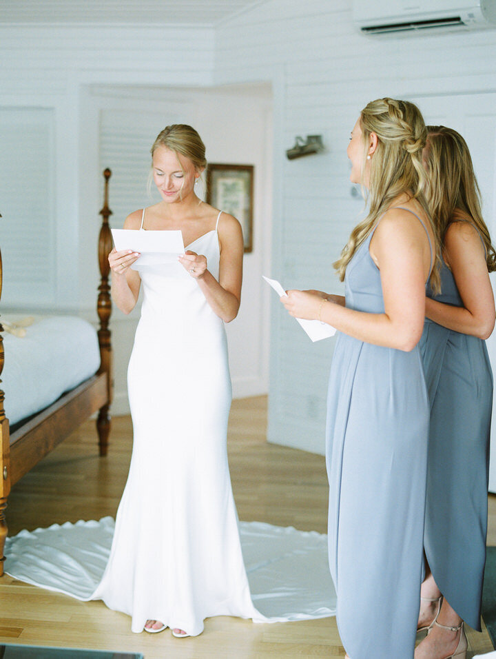 bride reading a note from groom during getting ready photos