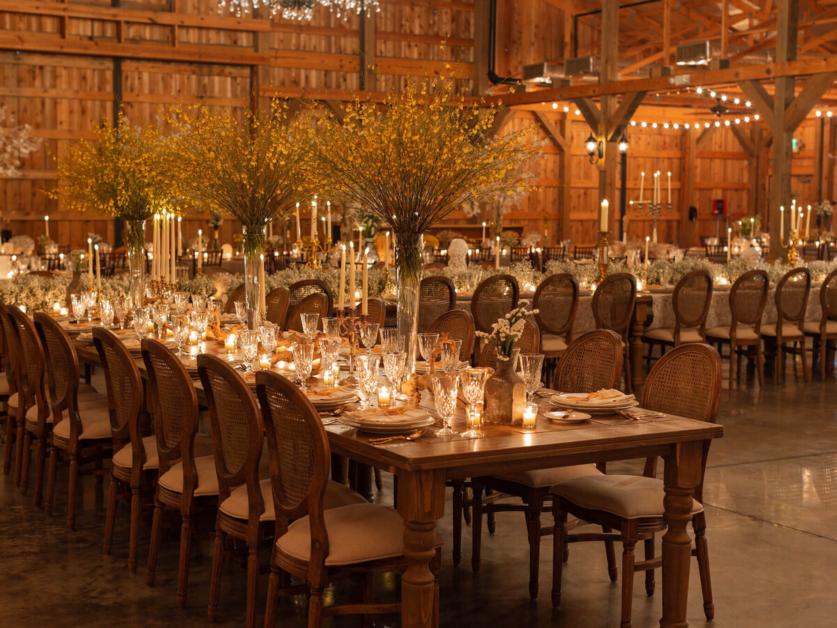 Golden wedding party with farm tables and variety of cenpterieces