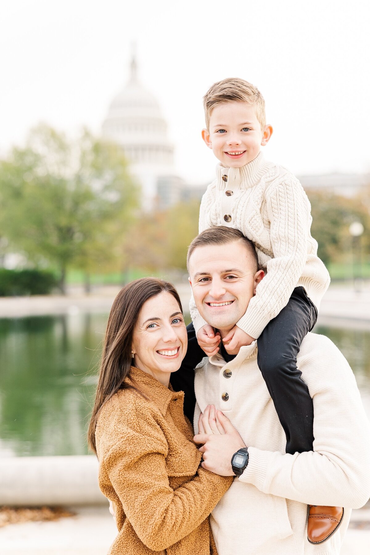 Little boy and his parents posing at a family photography session at the US Capitol