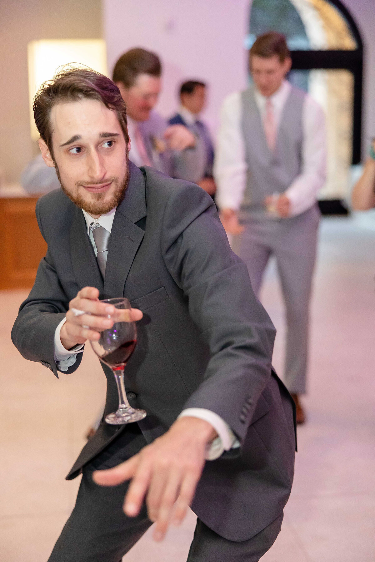 wedding guest holds wine glass while dancing at The Preserve at Canyon Lake