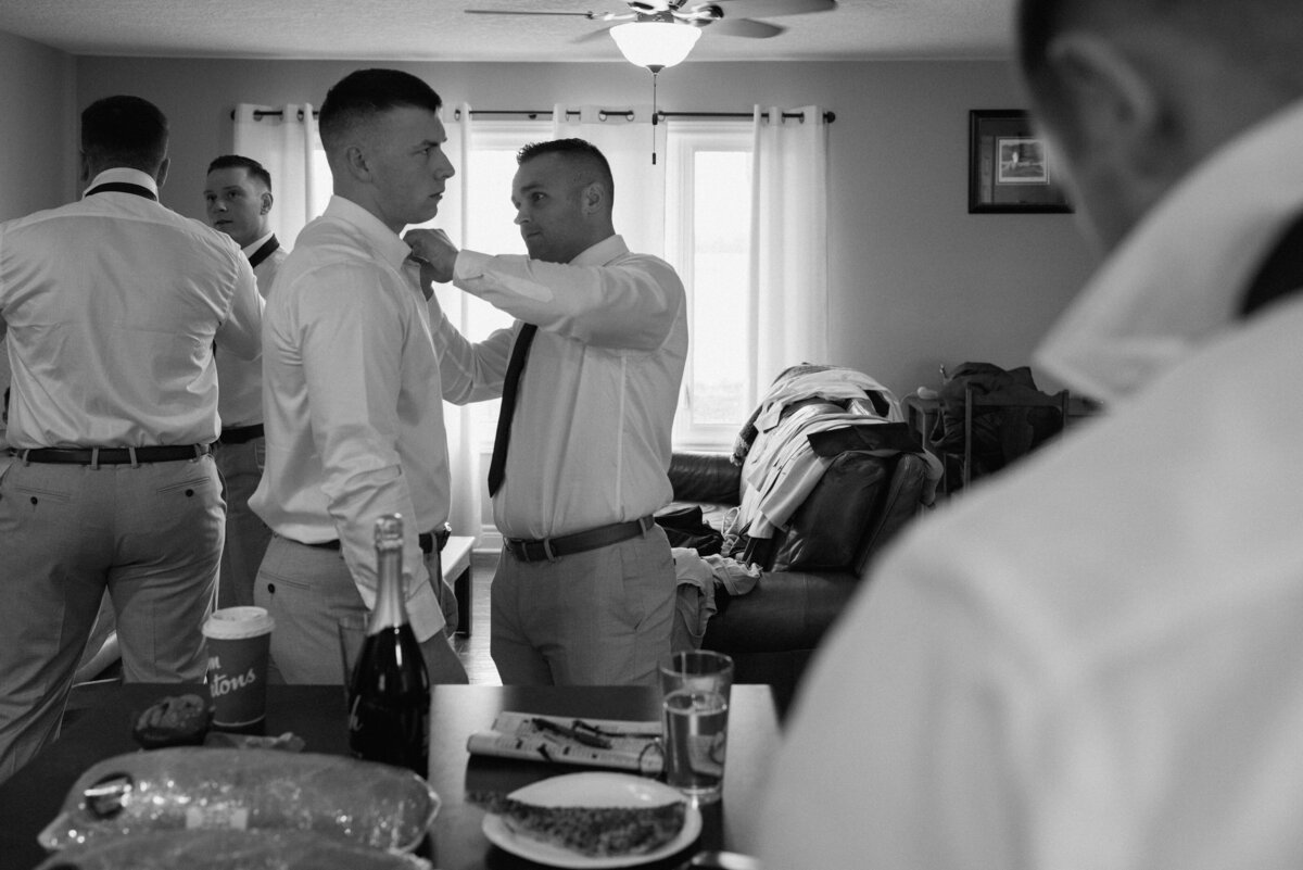 groom getting ready with help from a groomsman