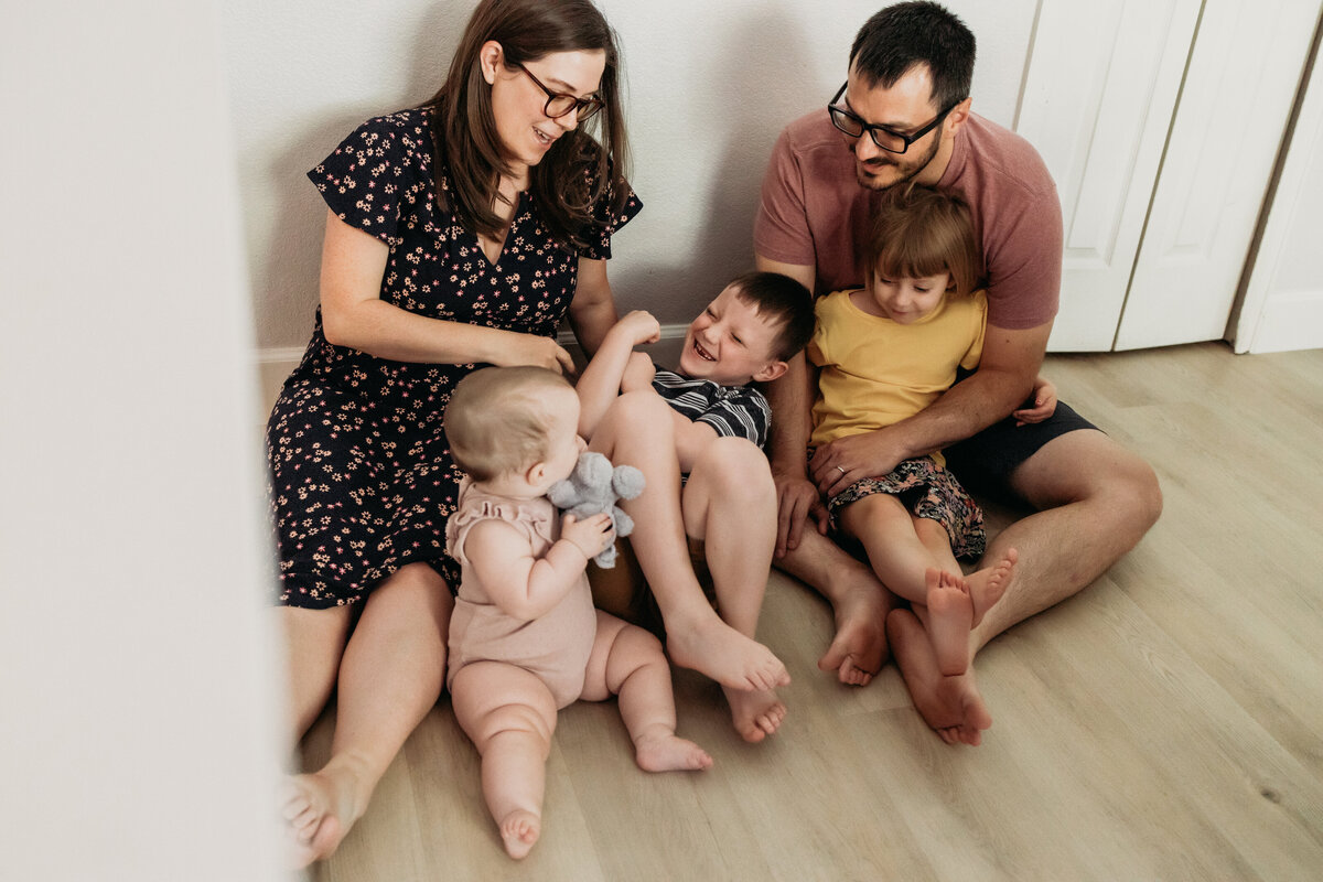family plays on kitchen floor for at home family session