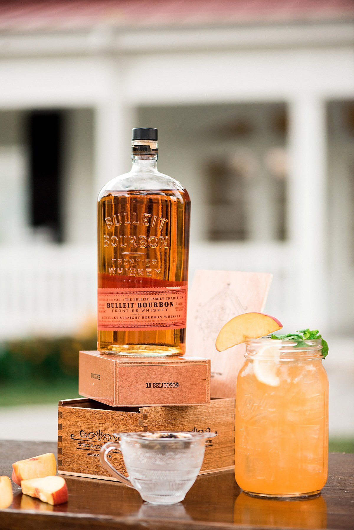 Signature wedding cocktail with peach and Bulleit Kentucky Bourbon for summer wedding at Ravenswood Mansion