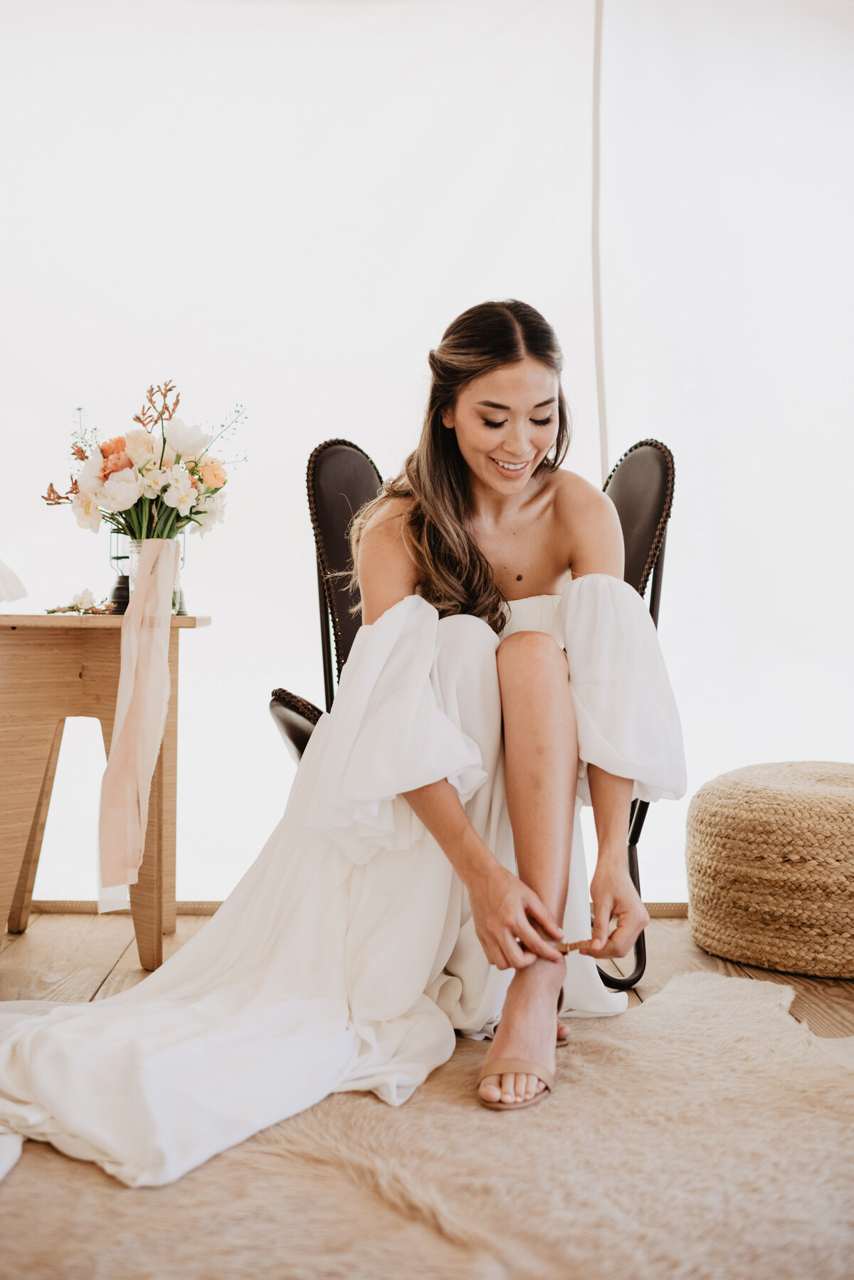 Utah Elopement Photographer captures bride getting shoes on for elopement