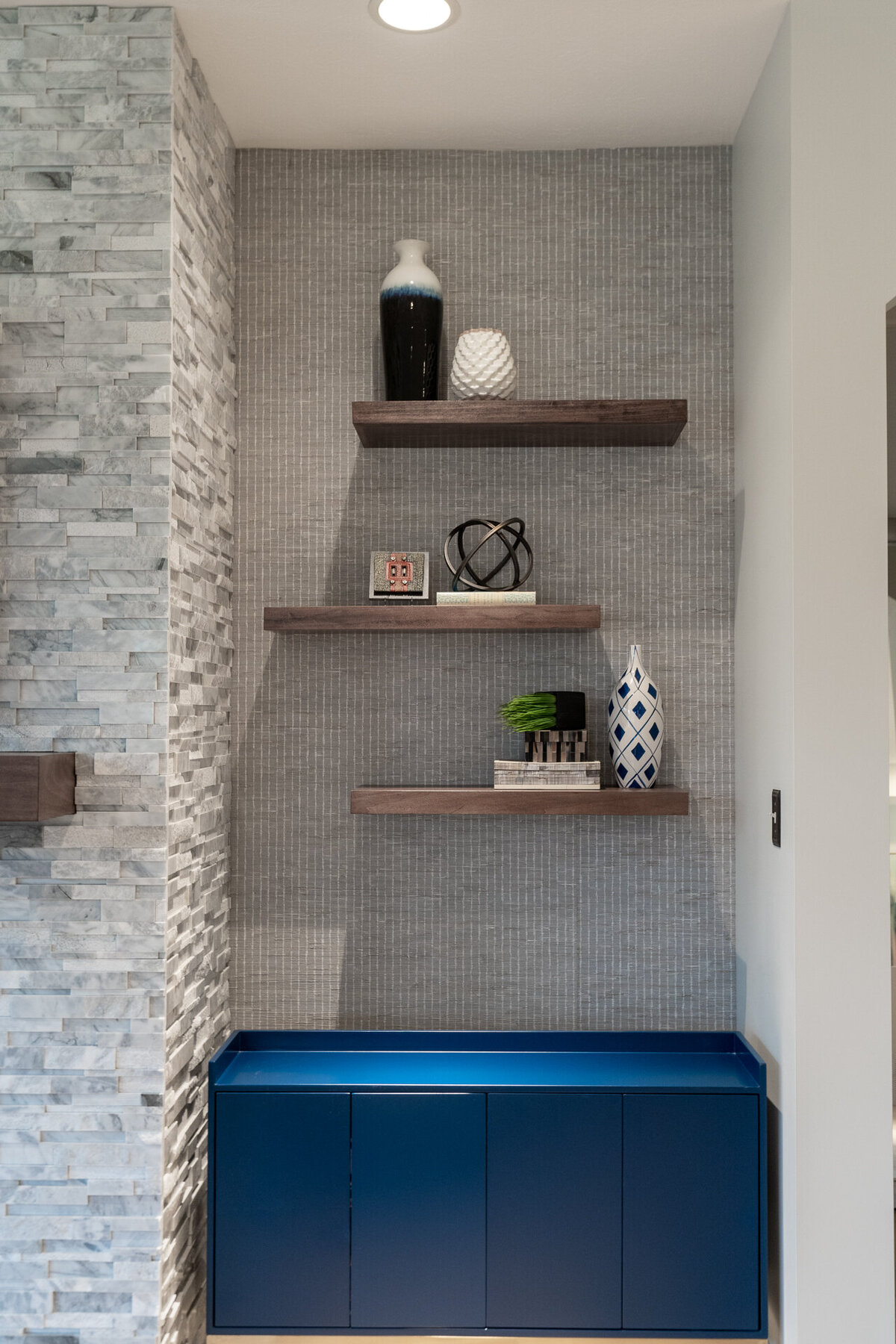 wooden block shelves on wall above blue ottoman