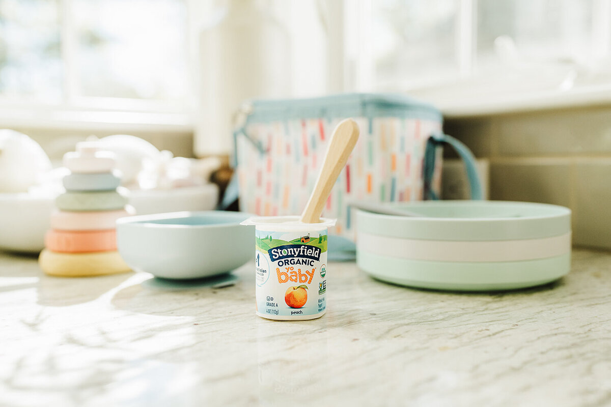 stonyfield farm yogurt cup with dishes and lunchboz