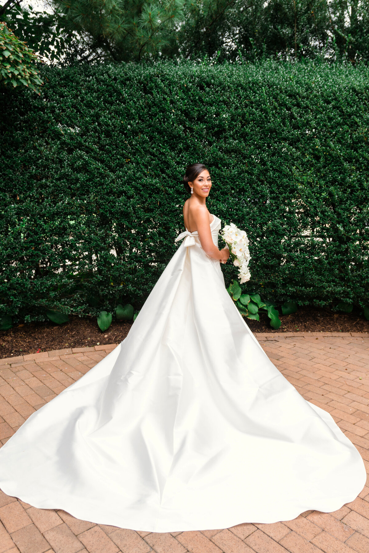 wedding photo of bride in her bridal gown outdoors at The Garden City Hotel