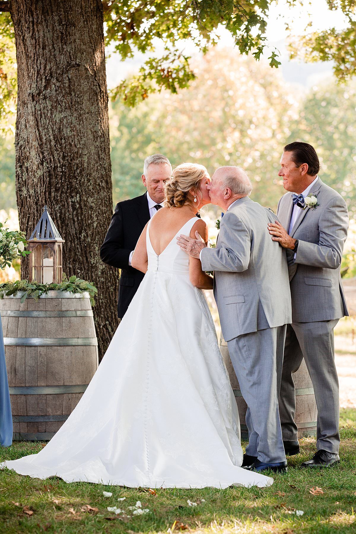 Father of the Bride kissing daughter on her cheek and giving her away on her wedding day at outdoor ceremony in Arrington