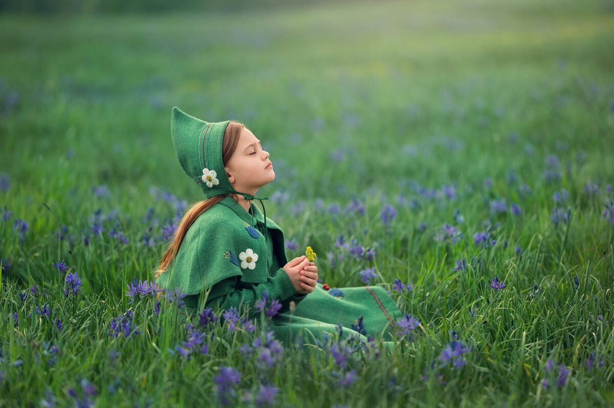 A girl sits in a field of lavender wearing a whimsical, Dutch-inspired attire while being photographed by Kara Reese of Waukesha, WI. .