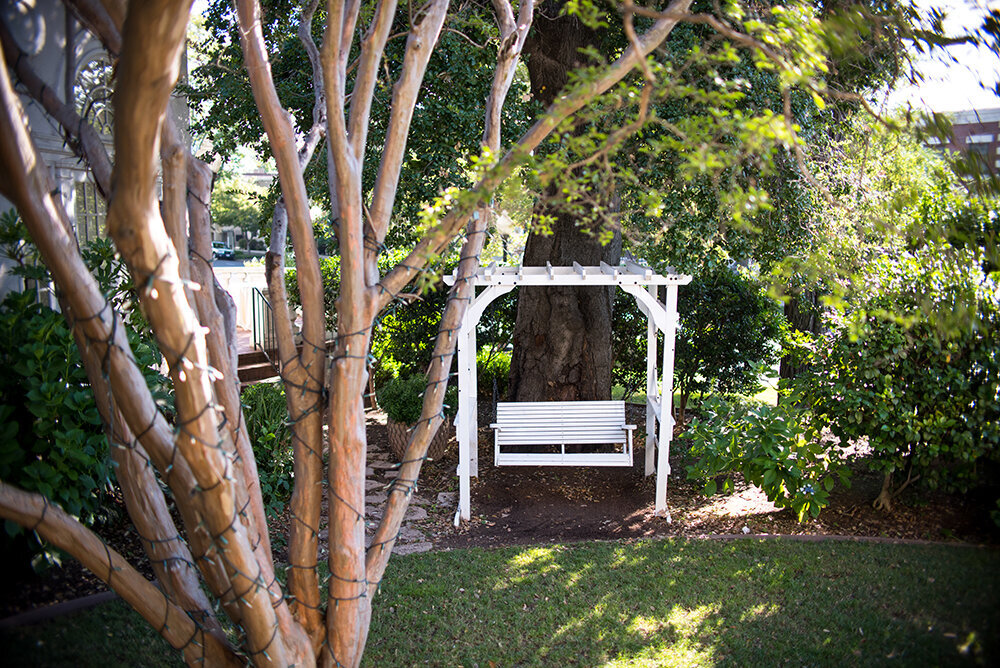 Tucked away under an oak tree, this swinging bench is a perfect hidden spot for a first look or a private moment.