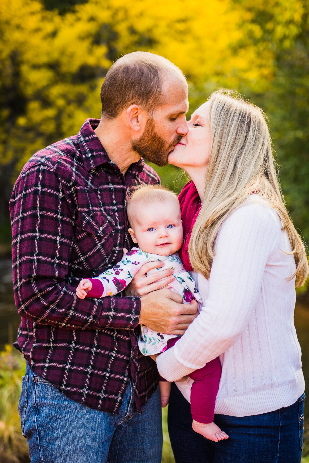 Sedona family photography Crescent Moon Ranch kissing over baby