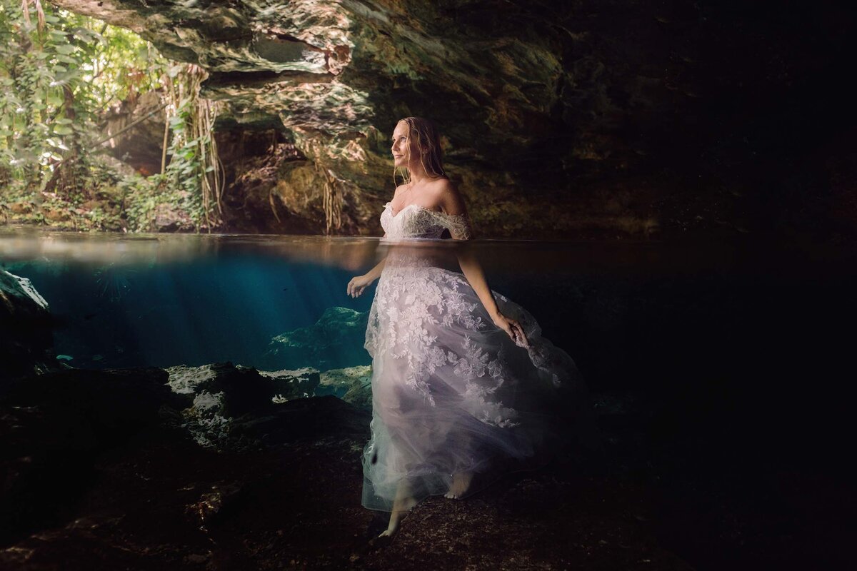Bride in waist deep water during trash the dress