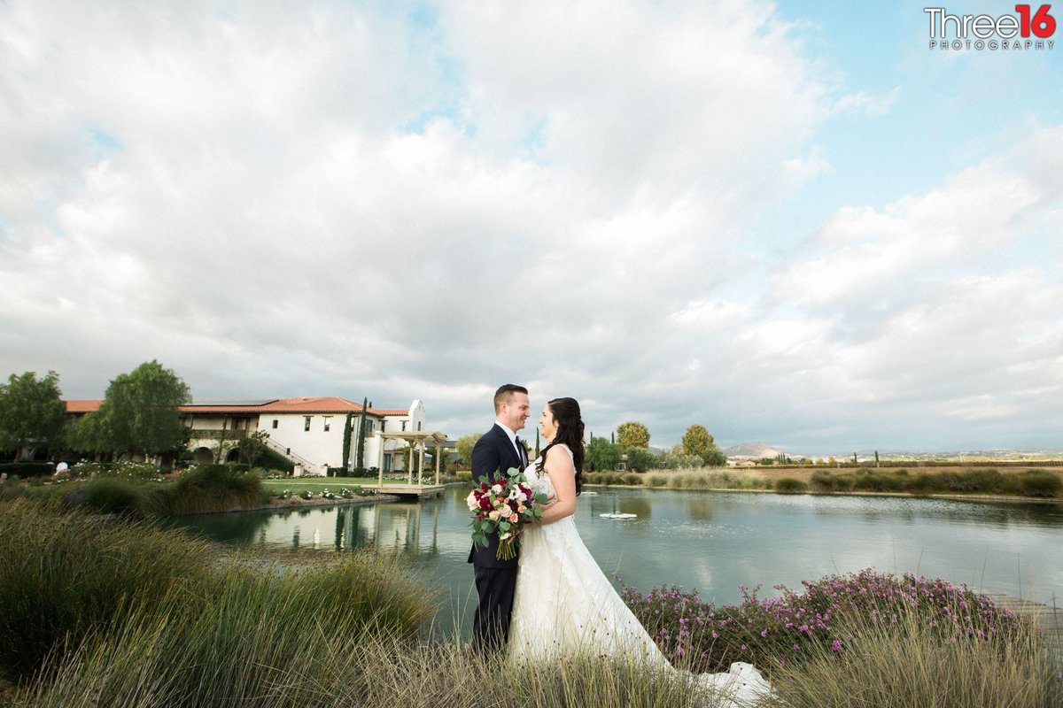 Bride and Groom in the fields next to a small lake