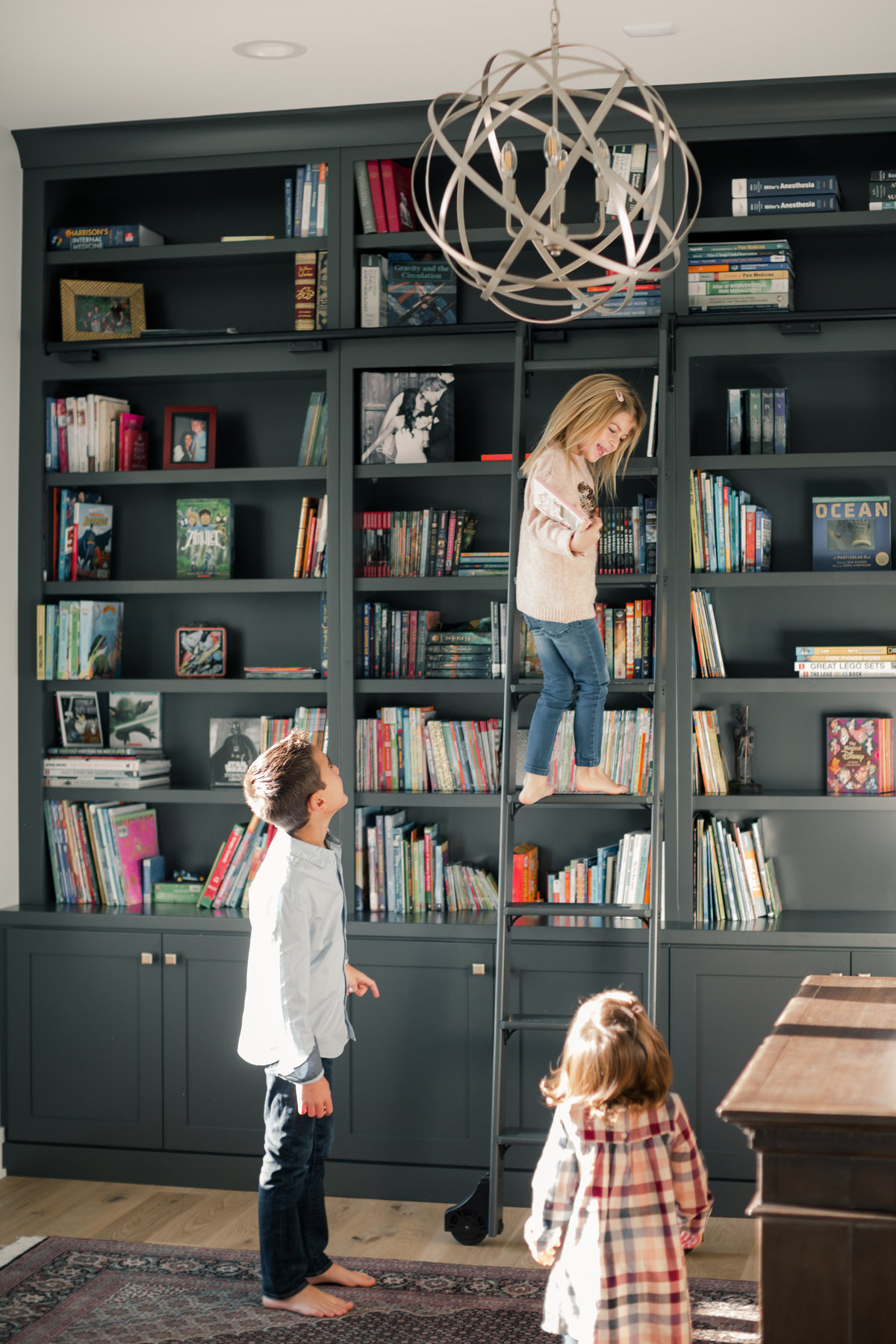 home office bookshelves with kids picking out books