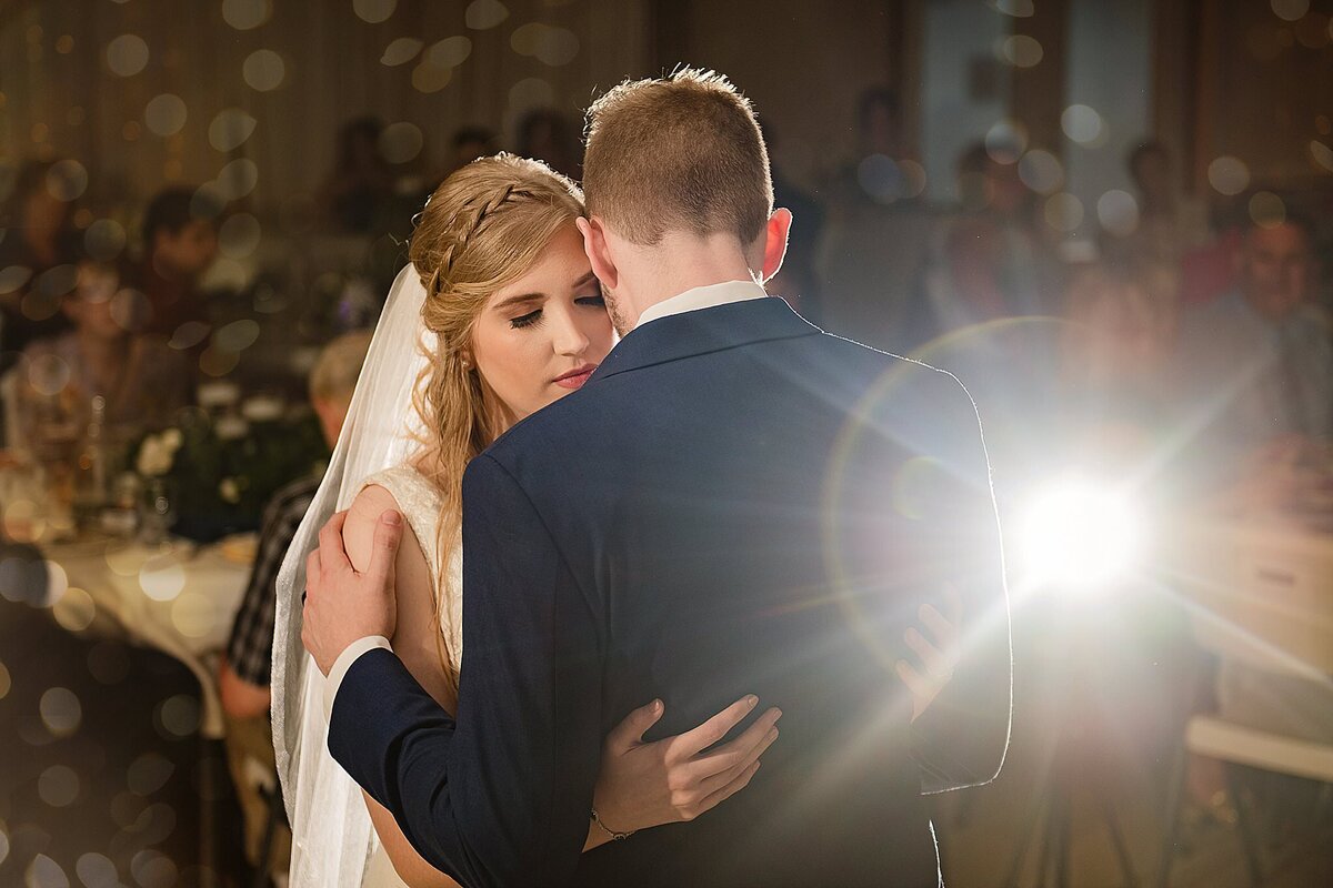 bride and groom dance with light flare