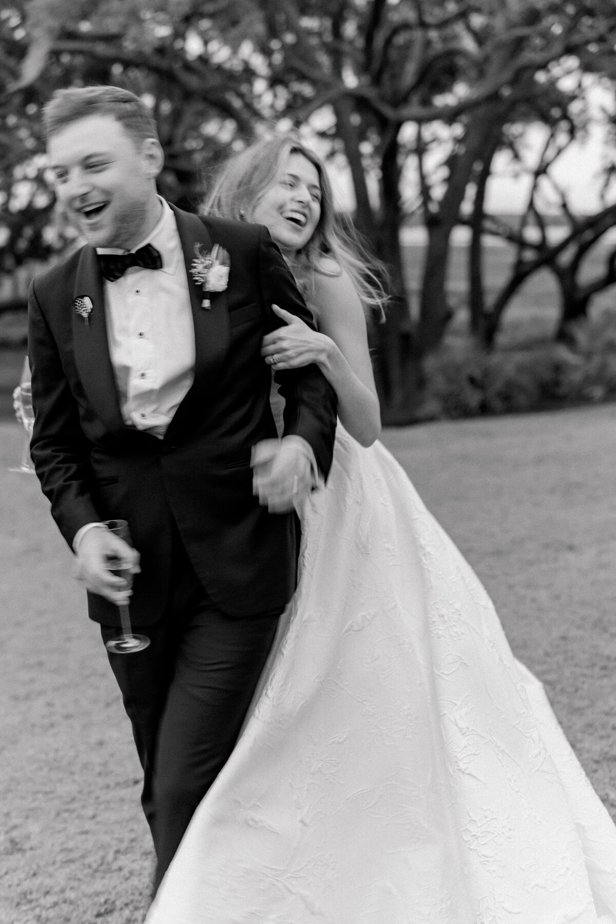 Candid black and white Charleston wedding photographer. Bride and groom fun motion blur photo. Kailee DiMeglio Photography.