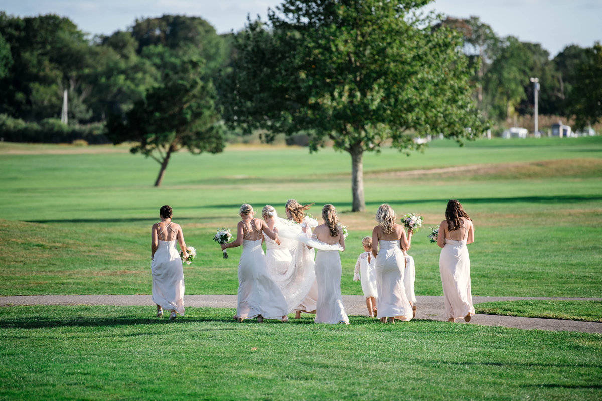 bridesmaids with bride on the greens for wedding at the Mansion at Timber Point