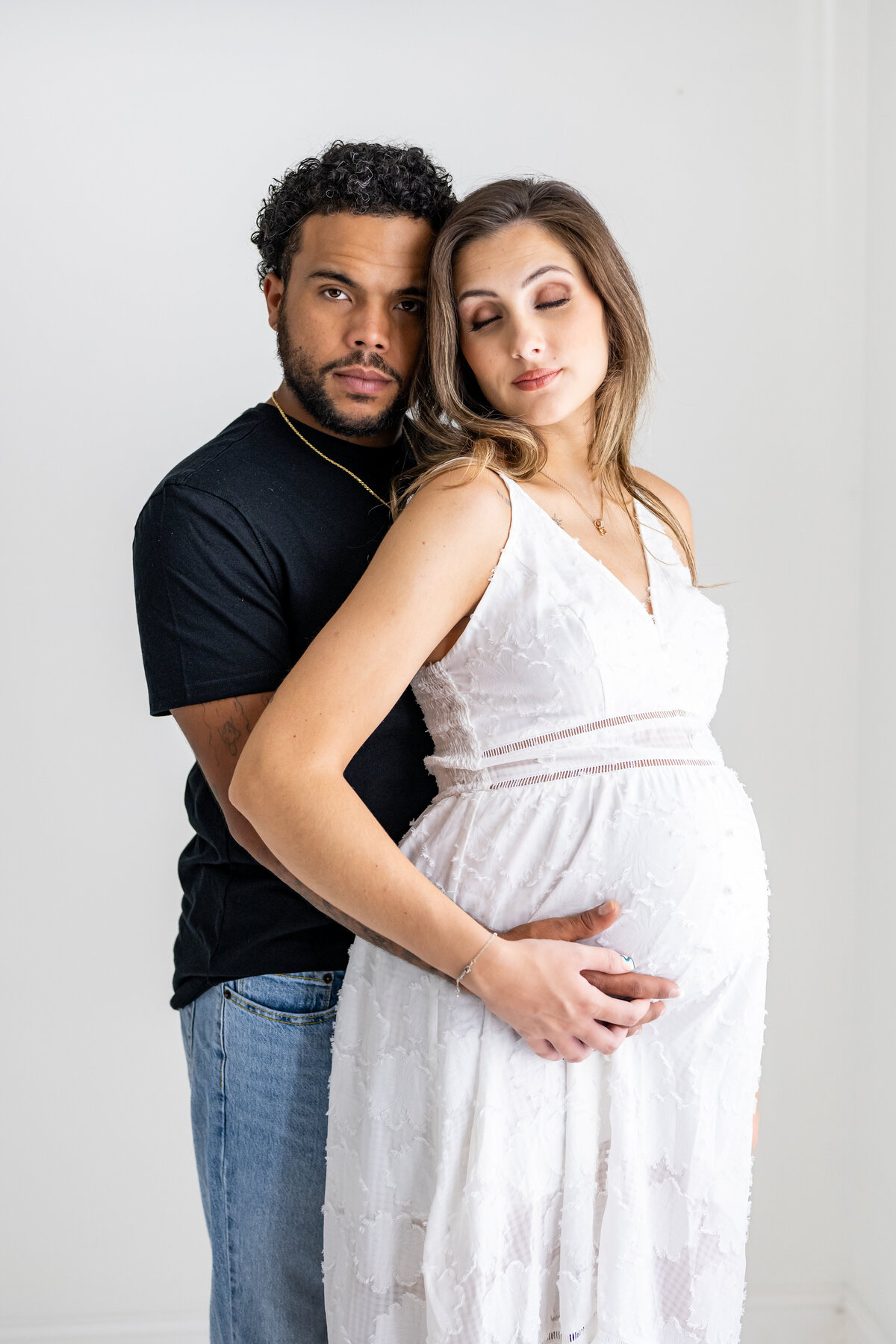 A couple embracing for their maternity pictures