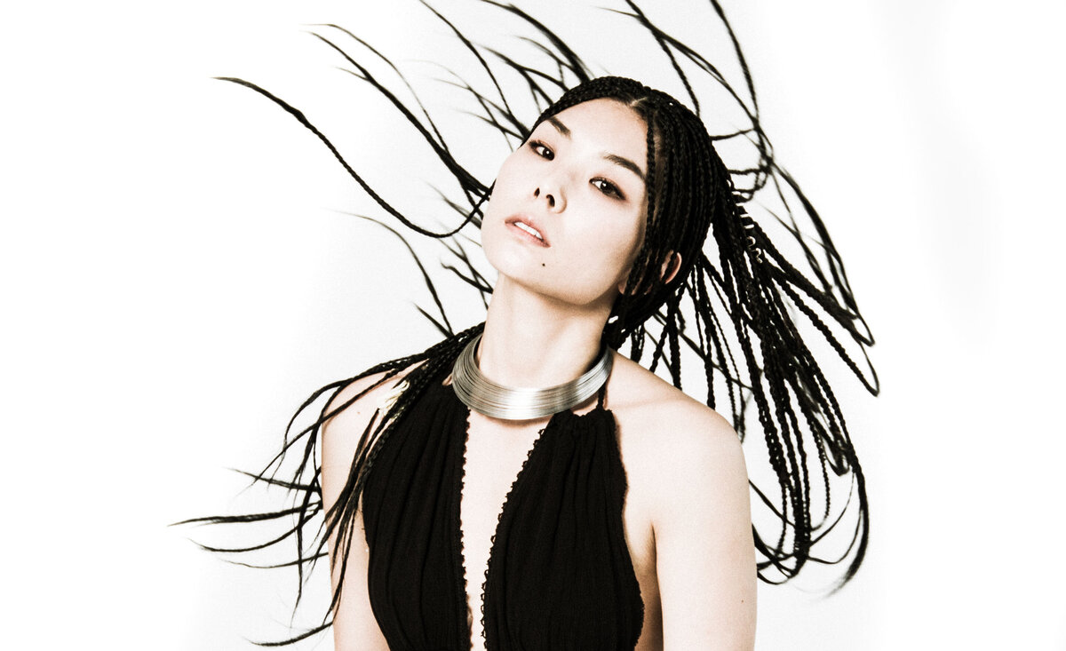 Female musician portrait Masumi wearing black dress swinging hair around
