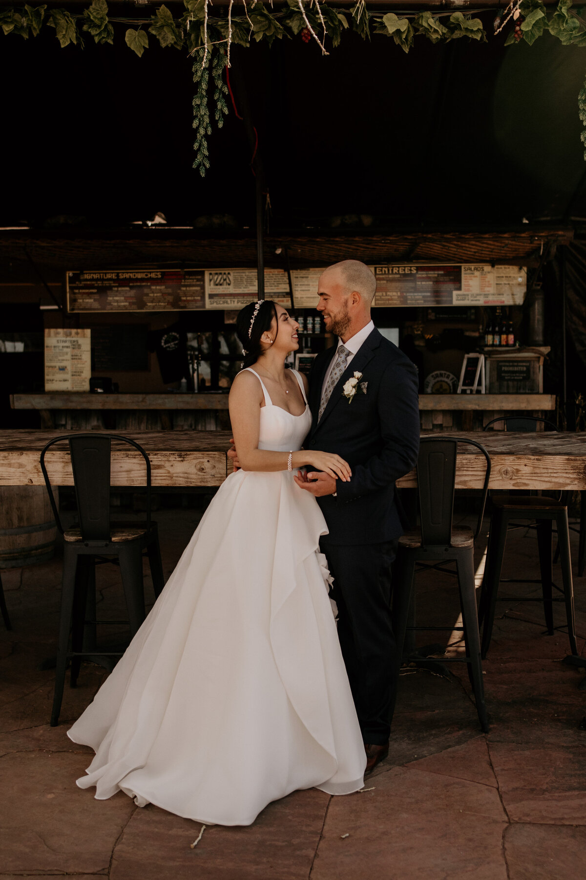 bride and groom standing together at a brewery in Santa Fe