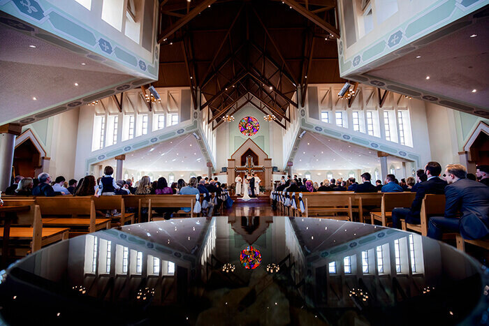 bride-groom-at-altar-water-reflection-church
