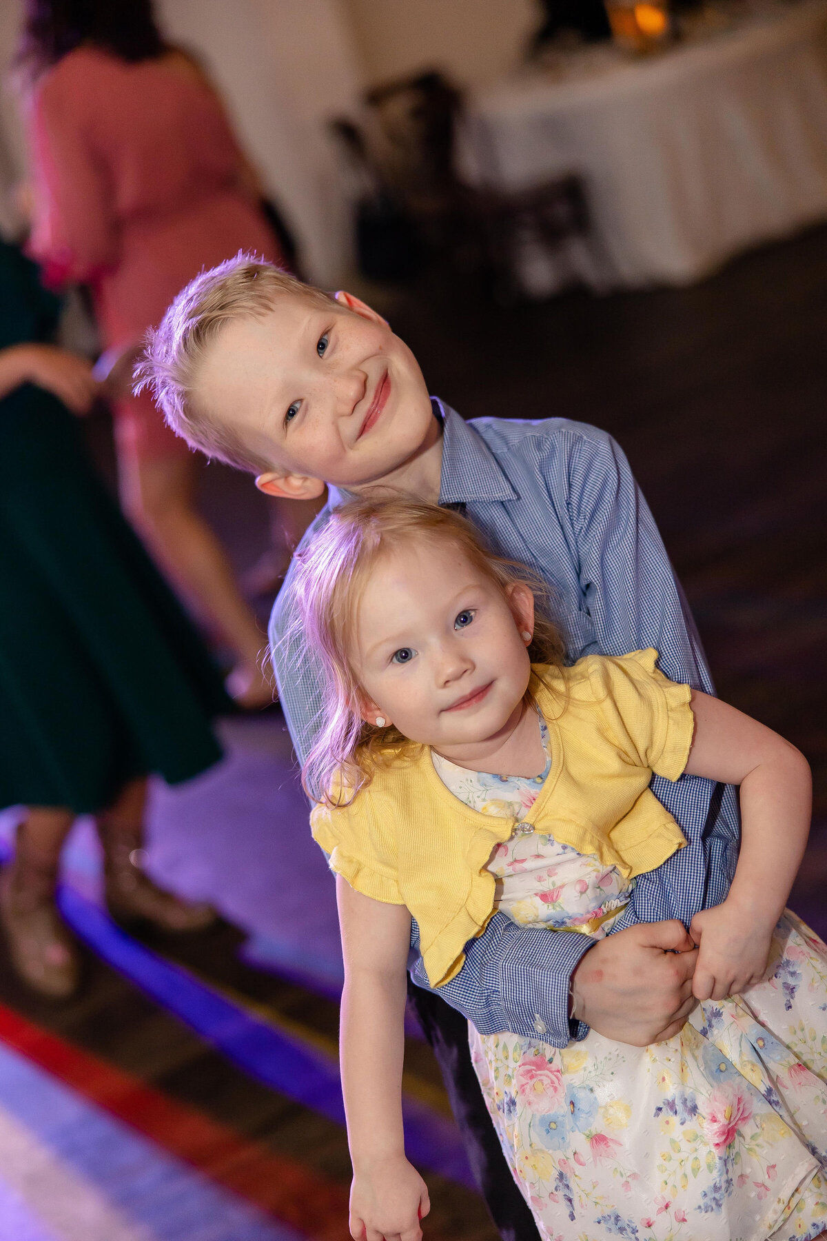 children at wedding reception hug and smile at Fort Worth wedding