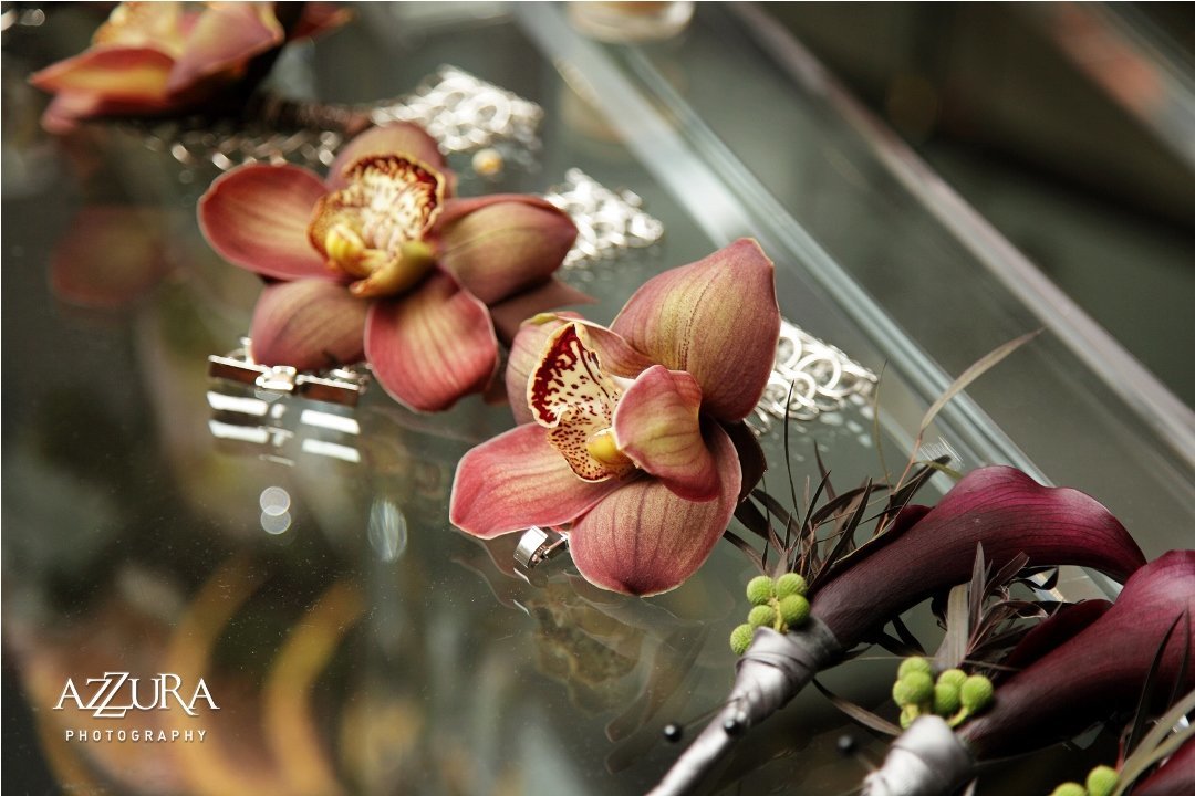 corsages of brown cymbidium orchids and boutonnieres of purple calla lilies