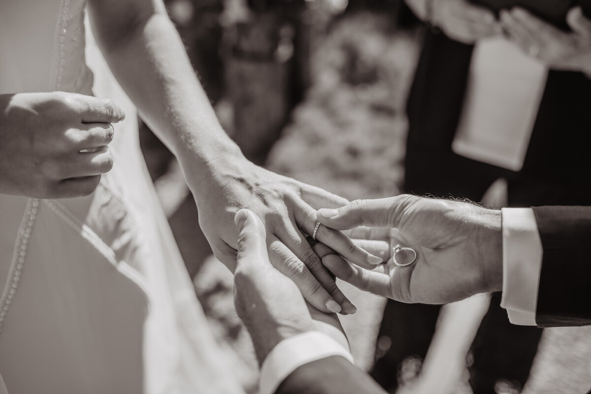 Photographers Jackson Hole capture groom placing ring on bride's finger