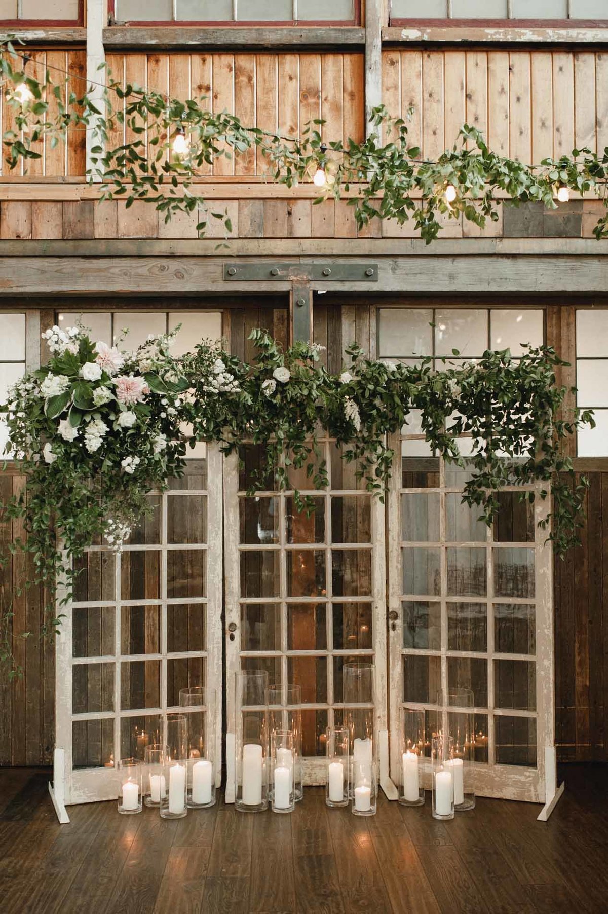 These reclaimed french doors that we covered in greens and cafe au lait dahlias make a striking wedding ceremony backdrop.