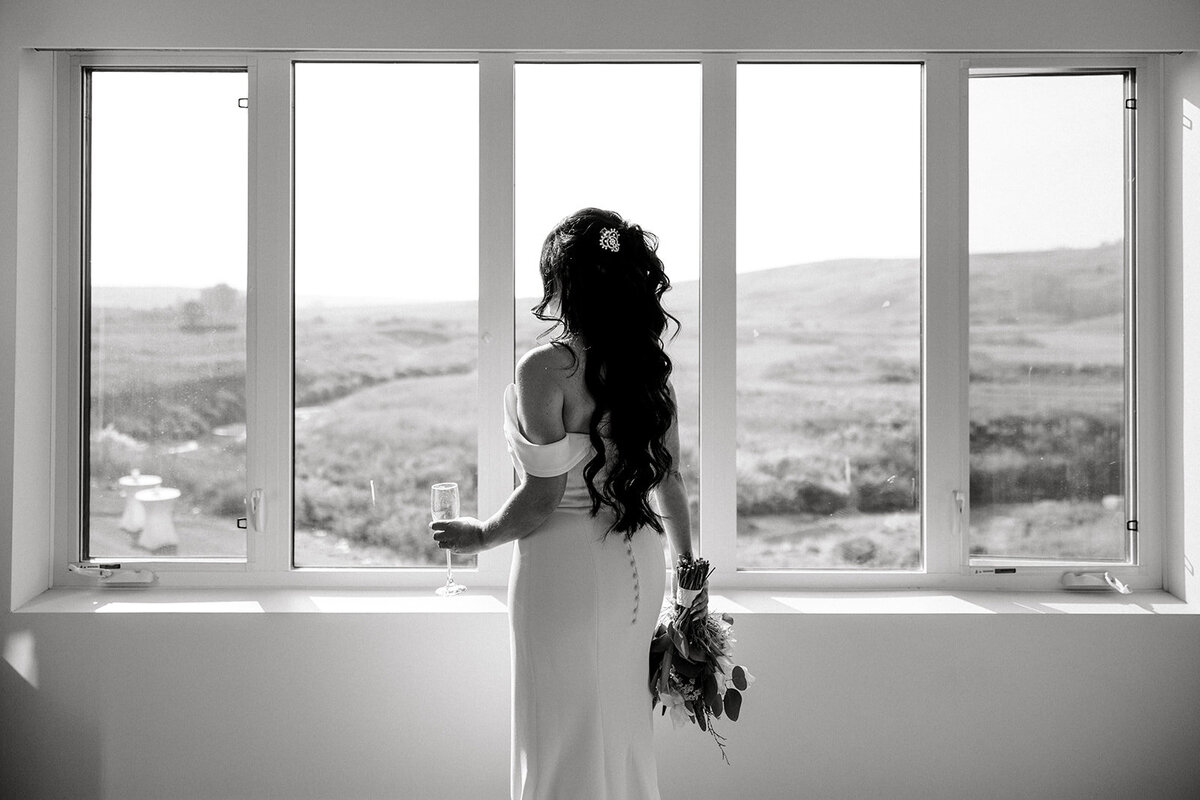 Bride looking out of windwo