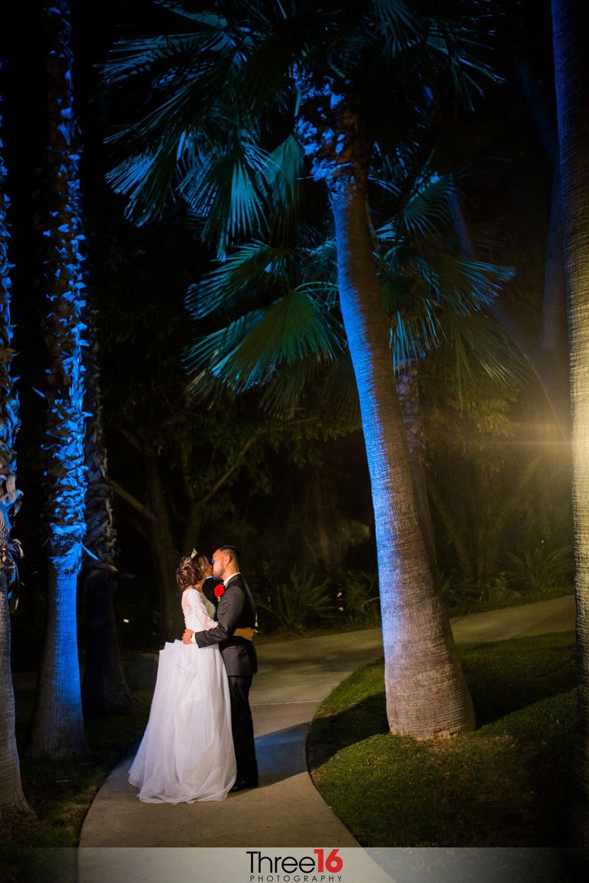 Intimate kiss between newly married couple at night