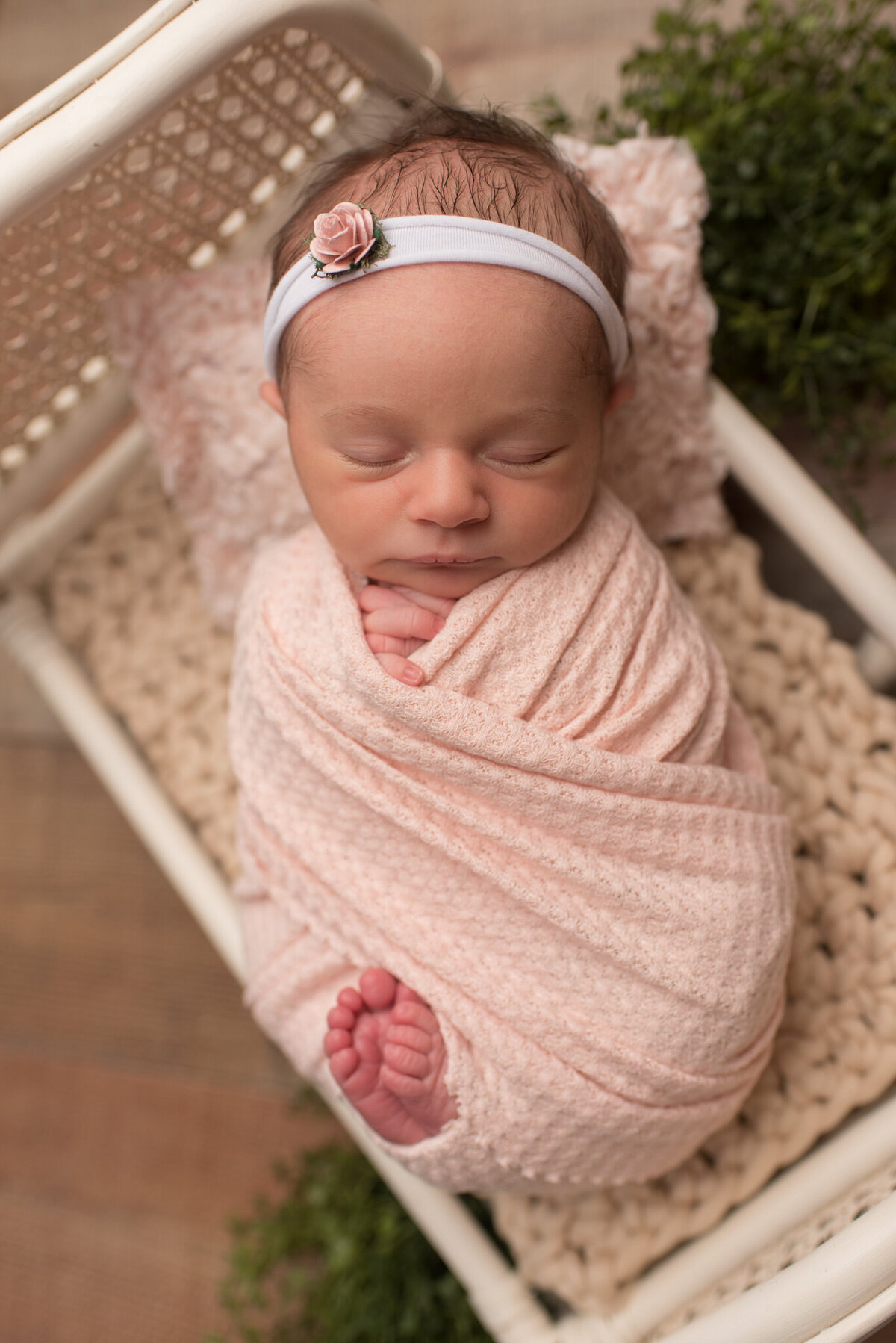 Baby girl wrapped in blush pink wrap