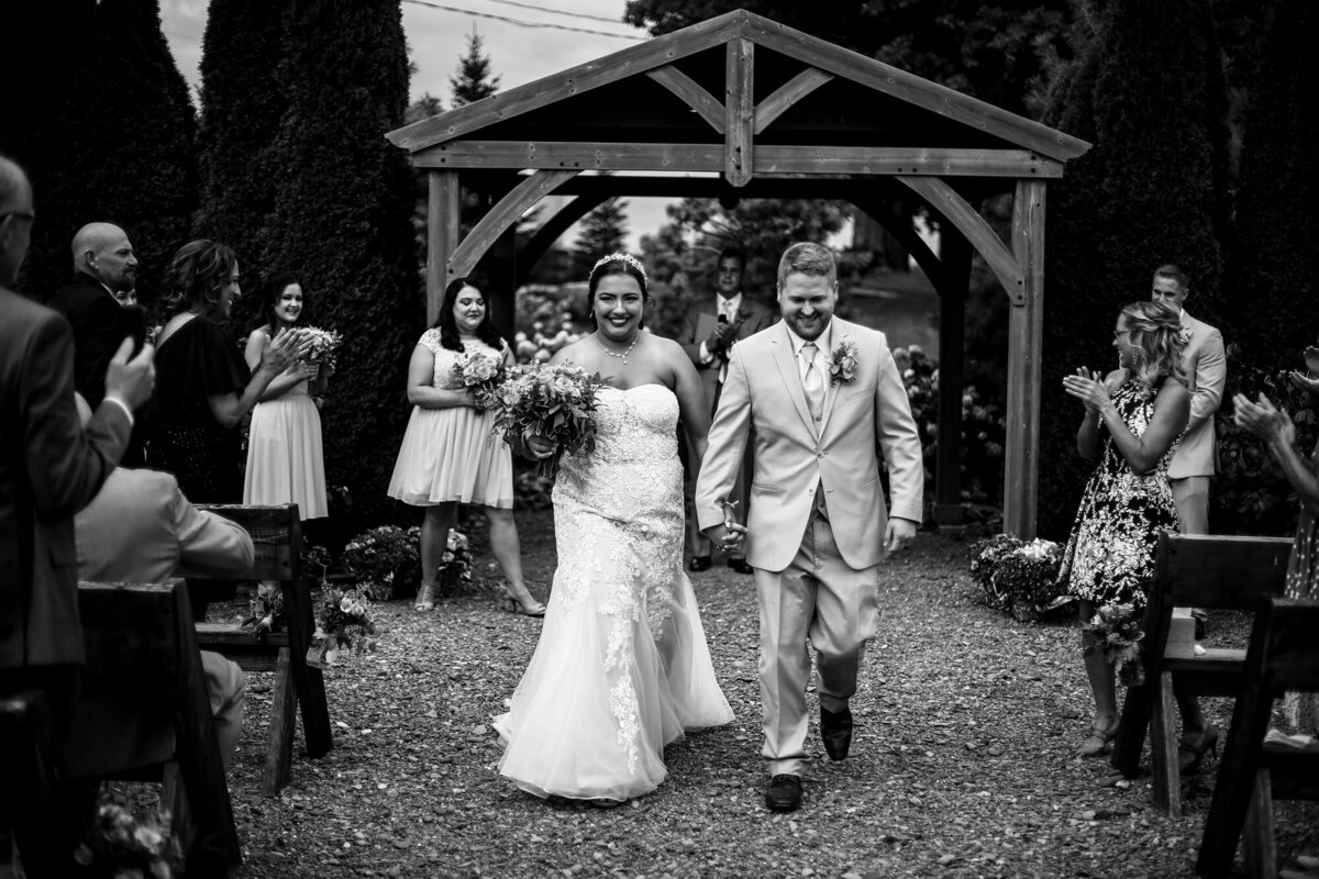 Recessional photo of bride and groom  at the end of their Port Farms wedding ceremony