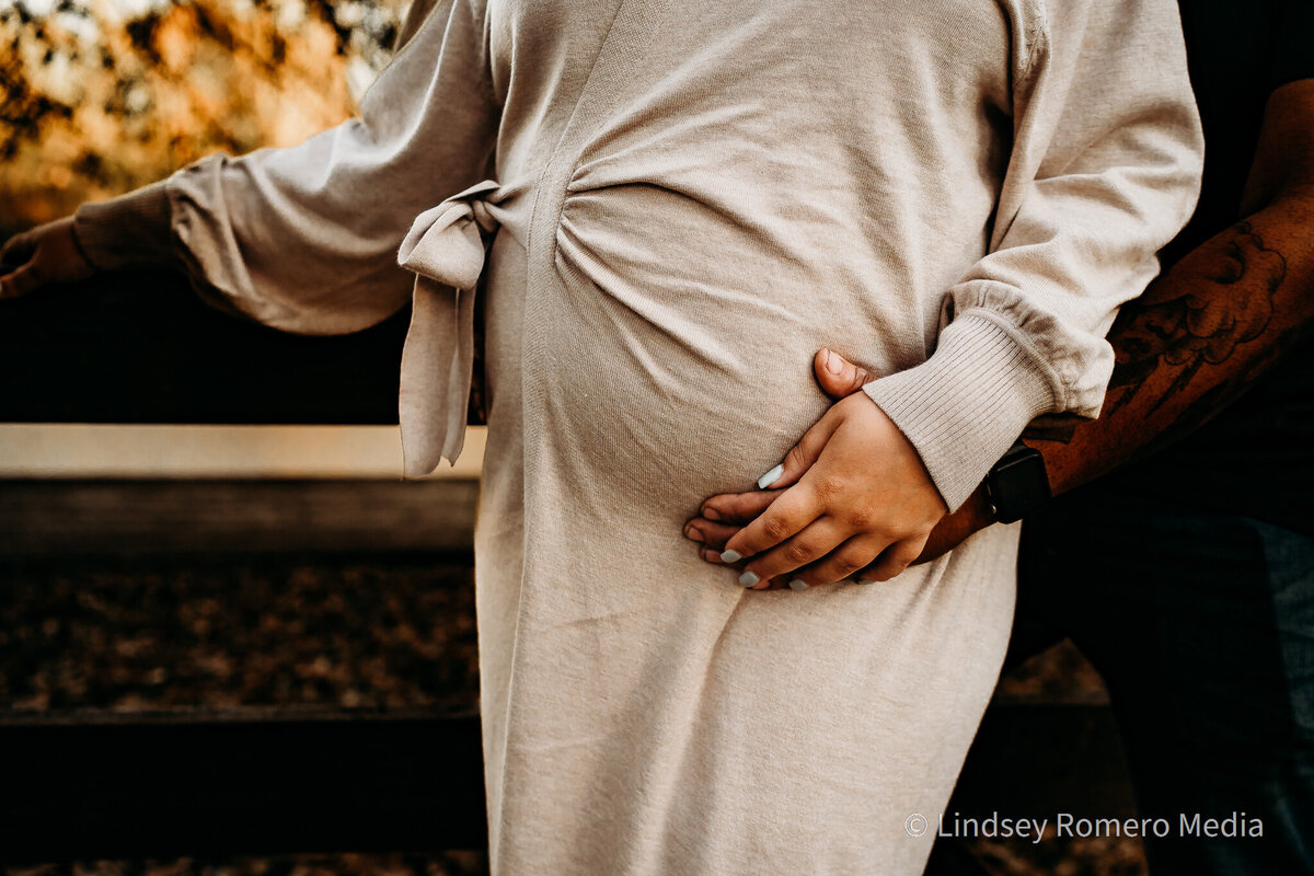 close up pregnancy photo, holding hands, in Lafayette, la