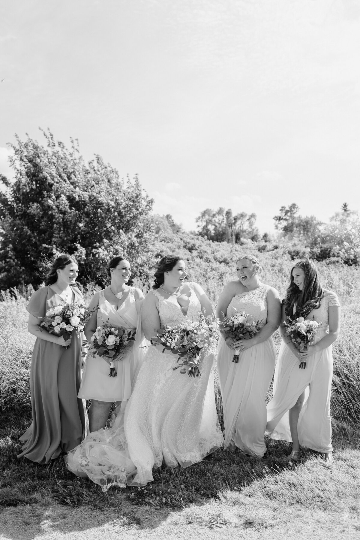 the bride and her bridal party laugh