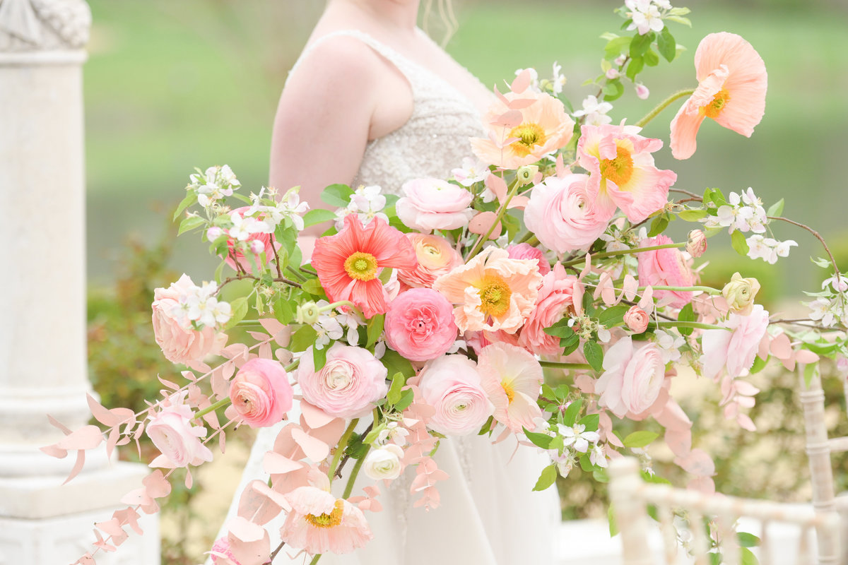 Beautiful big pink bouquet held by bride