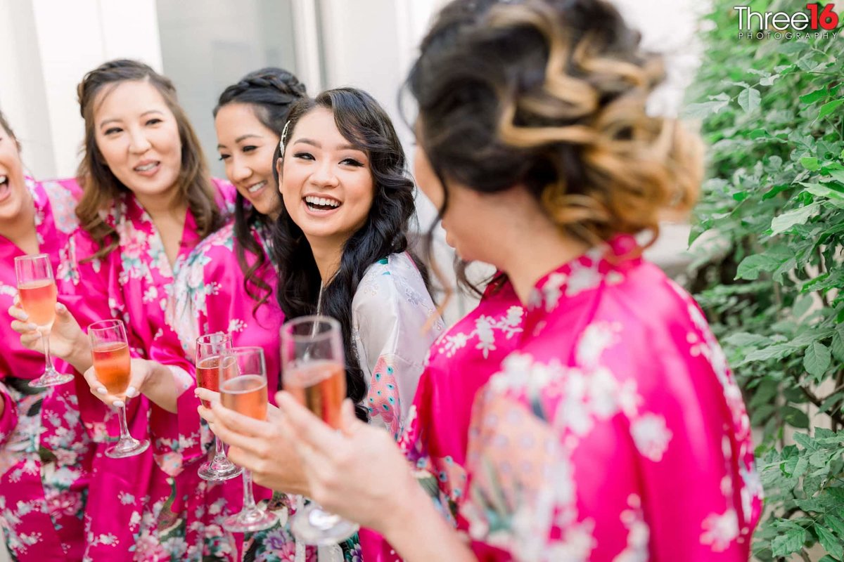Bride and her Bridesmaids share a glass of Champaign  before getting dressed