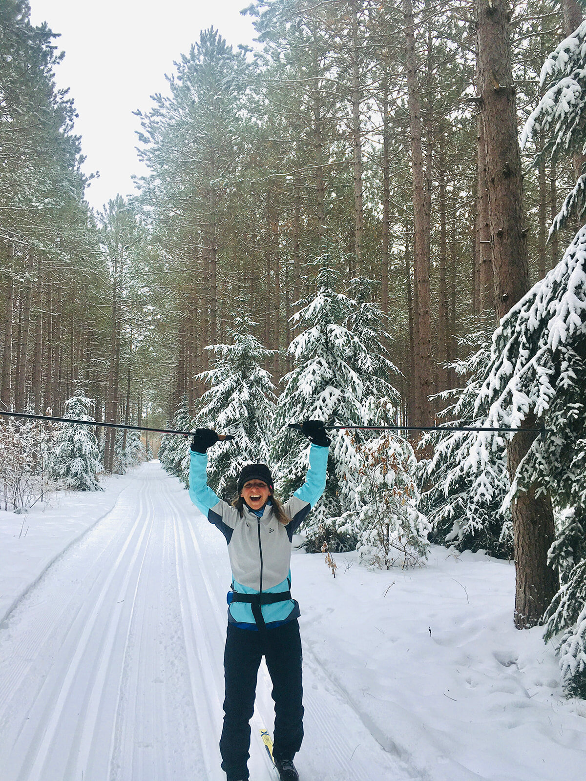 Aimee Harmon raises her skis ion the air during a cross country ski trip