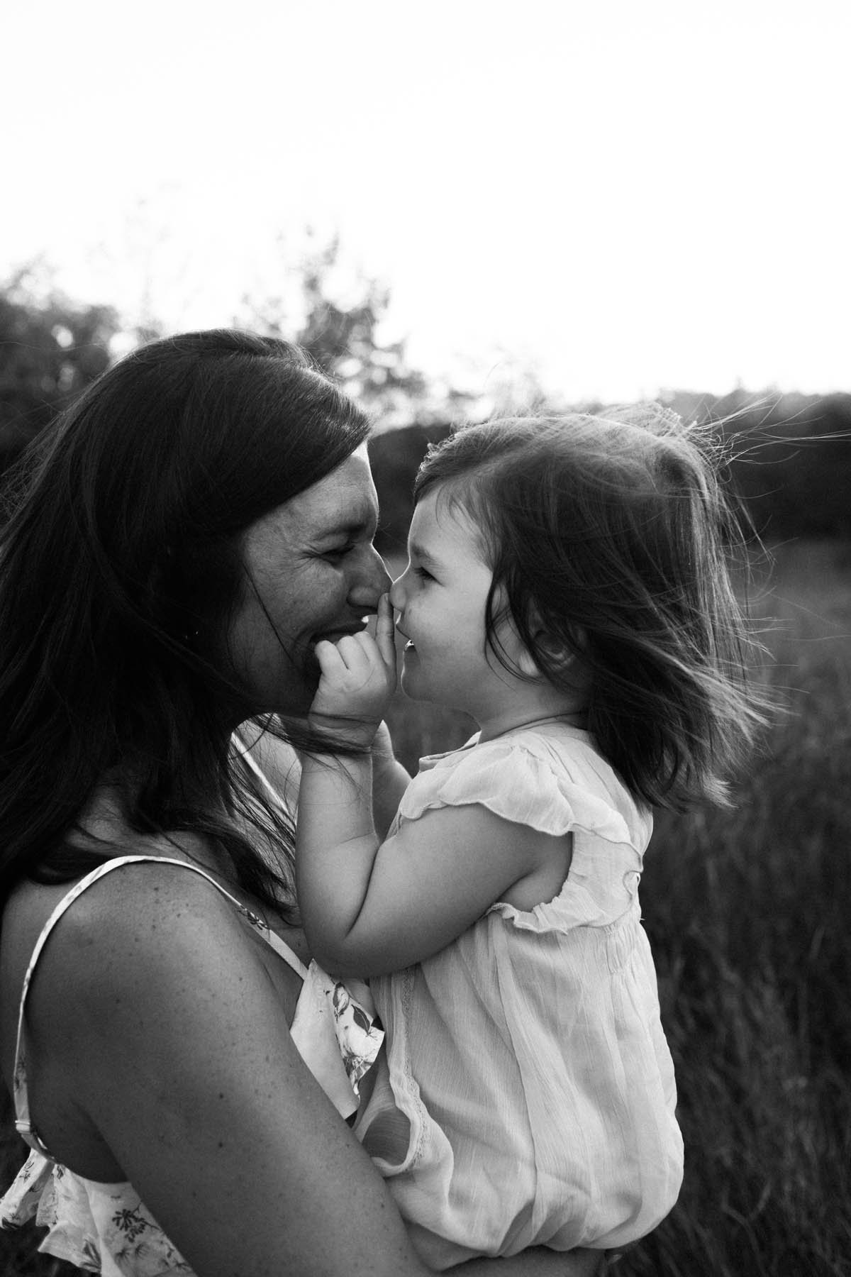 Mom and daughter touching nose to nose during photo session, Photo by Elle Baker Photography