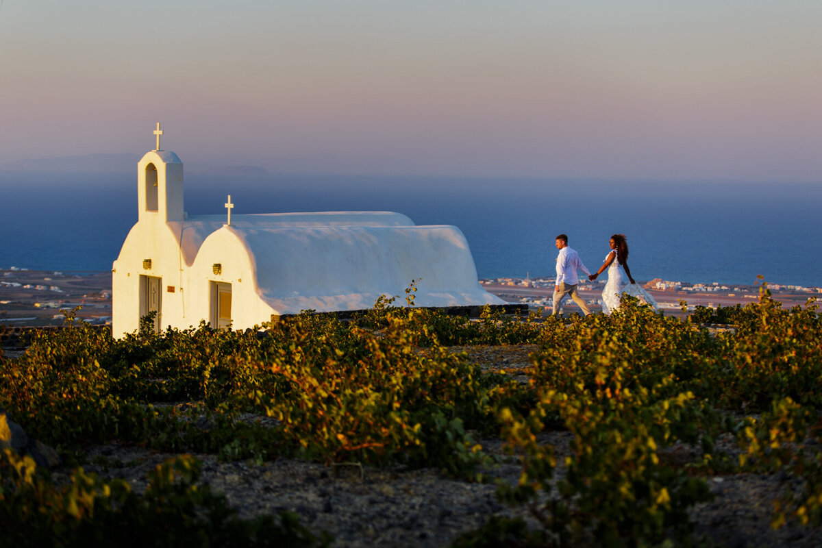 wedding couple walking in Santorini Greece