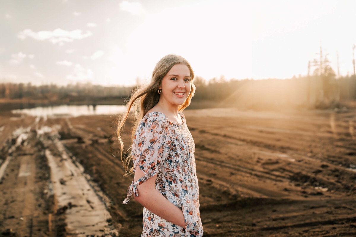 teen girl standing in dirt  during Springfield Mo senior photography session
