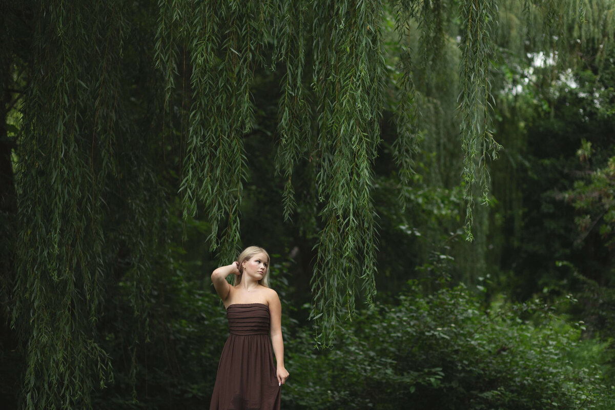 girl in brown dress by weeping willow tree