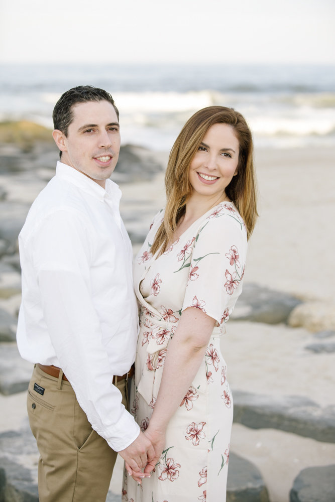 engaged couple on beach in spring lake