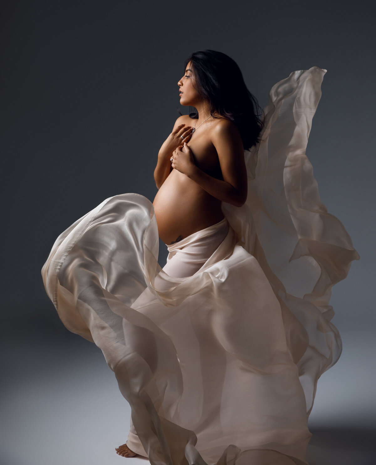 maternity photoshoot with  beige flying fabric