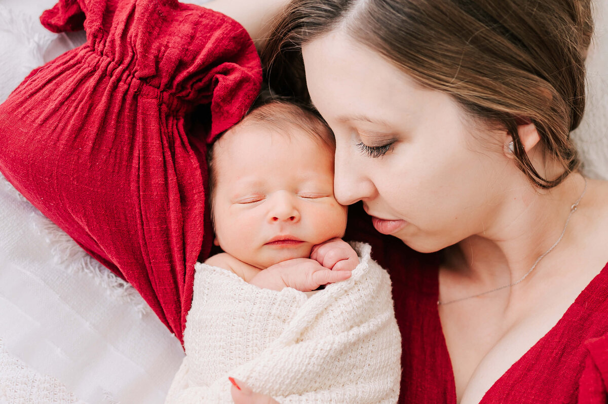 Springfield MO newborn photographer captures mom cuddling sleeping baby boy