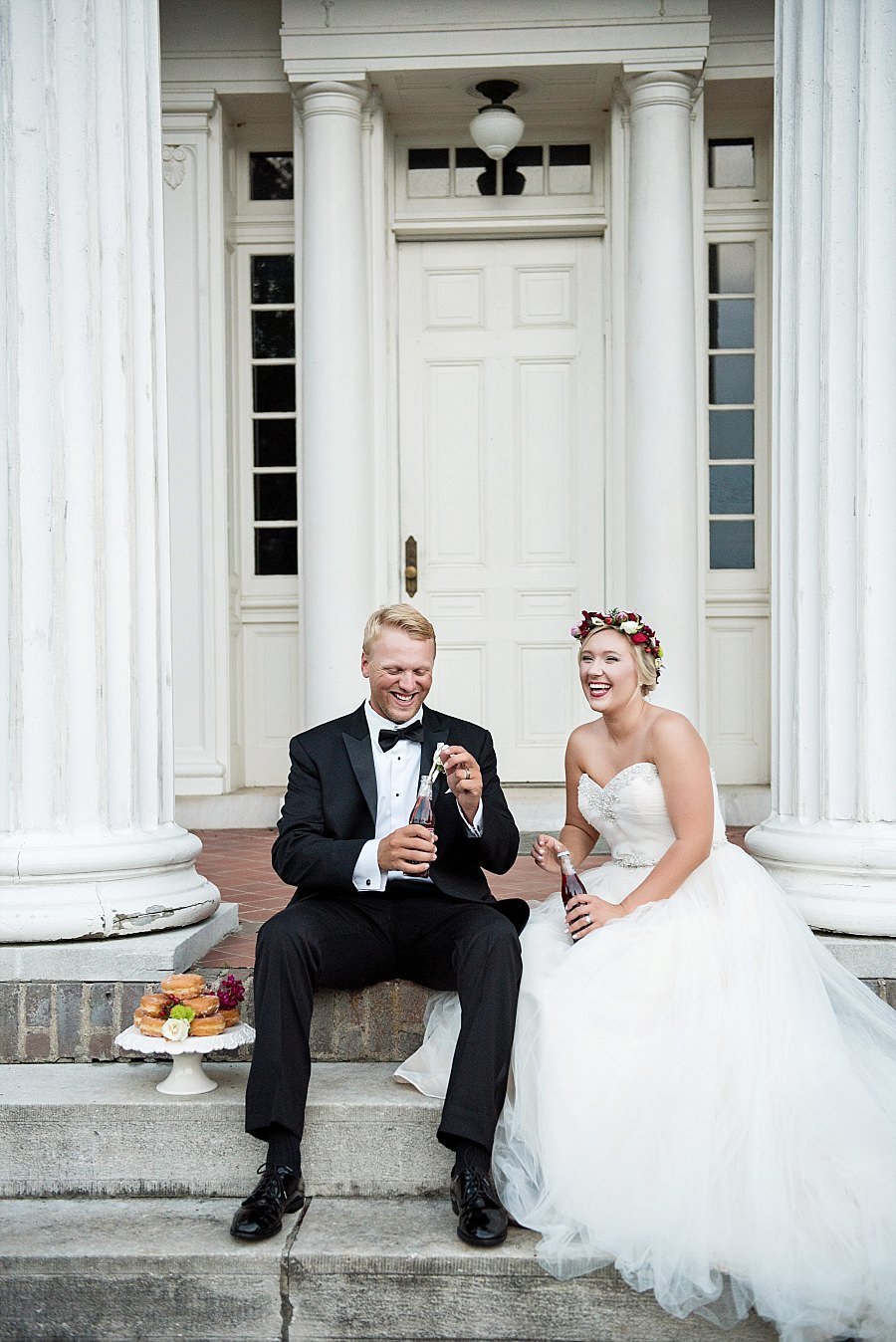 Couple sharing donuts and cheerwine on the steps of historic mansion in Tennessee