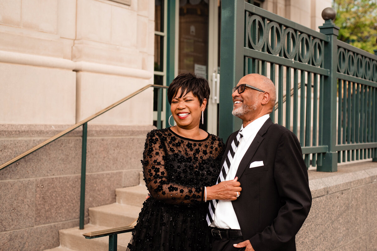 Anniversary photoshoot of married couple wearing formal wear outside of Schermerhorn laughing together